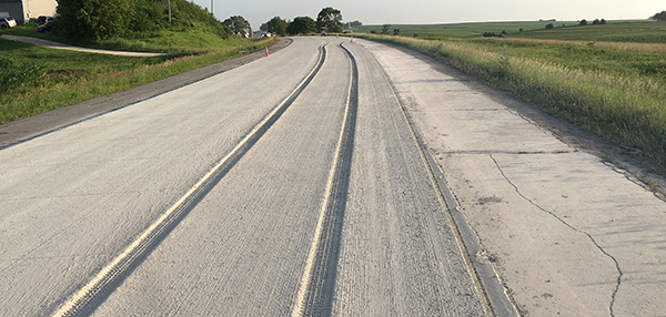 Photo of concrete with tire tracks.